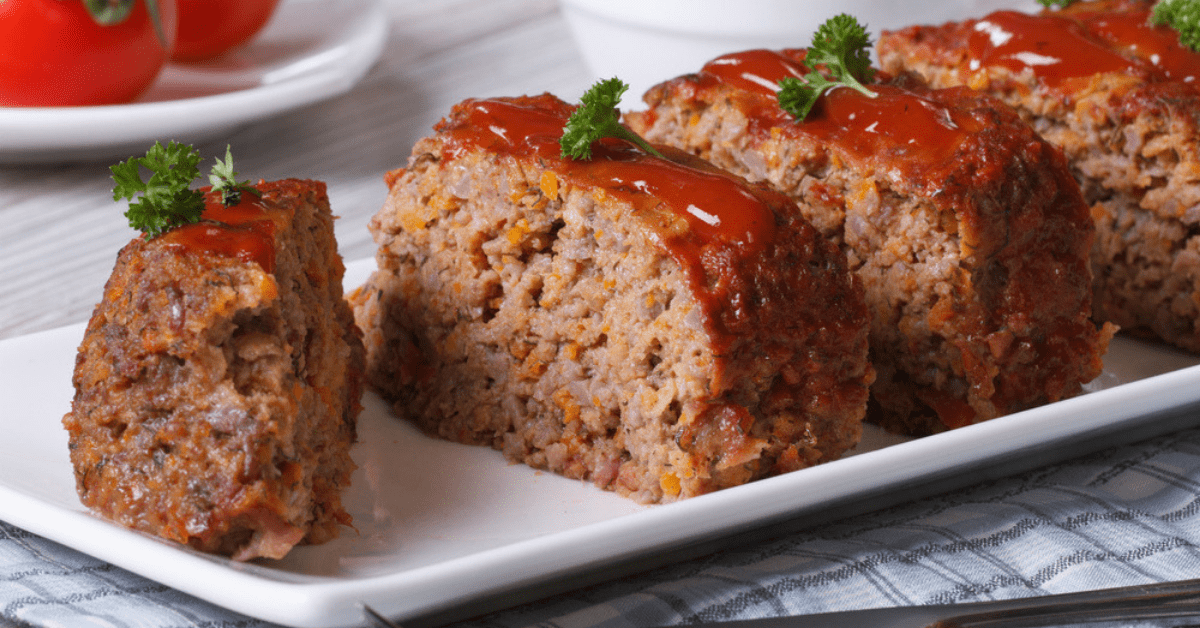 Sliced meatloaf with catsup on top. 