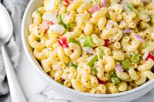 Amish Macaroni Salad in a White Bowl with a Spoon