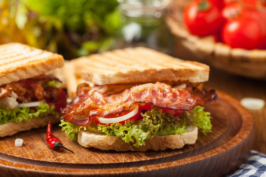 Toasted sandwich with bacon, tomato, cucumber and lettuce