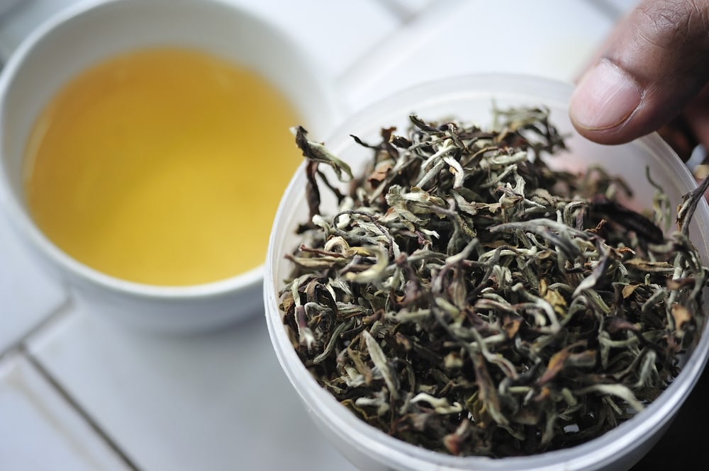 Dried Darjeeling Tea Leaves and a Cup of Tea