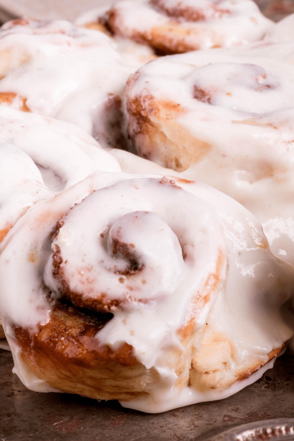 Closeup of Bisquick Cinnamon Rolls topped with sugar glaze. 