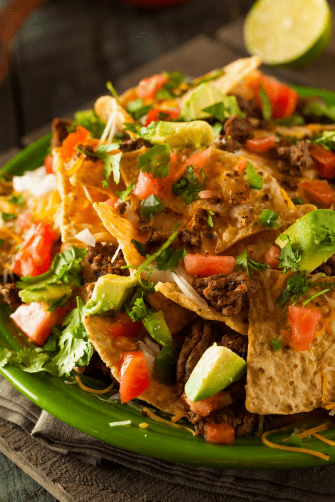 Loaded Nachos with Avocado, Tomatoes and Chopped Onions