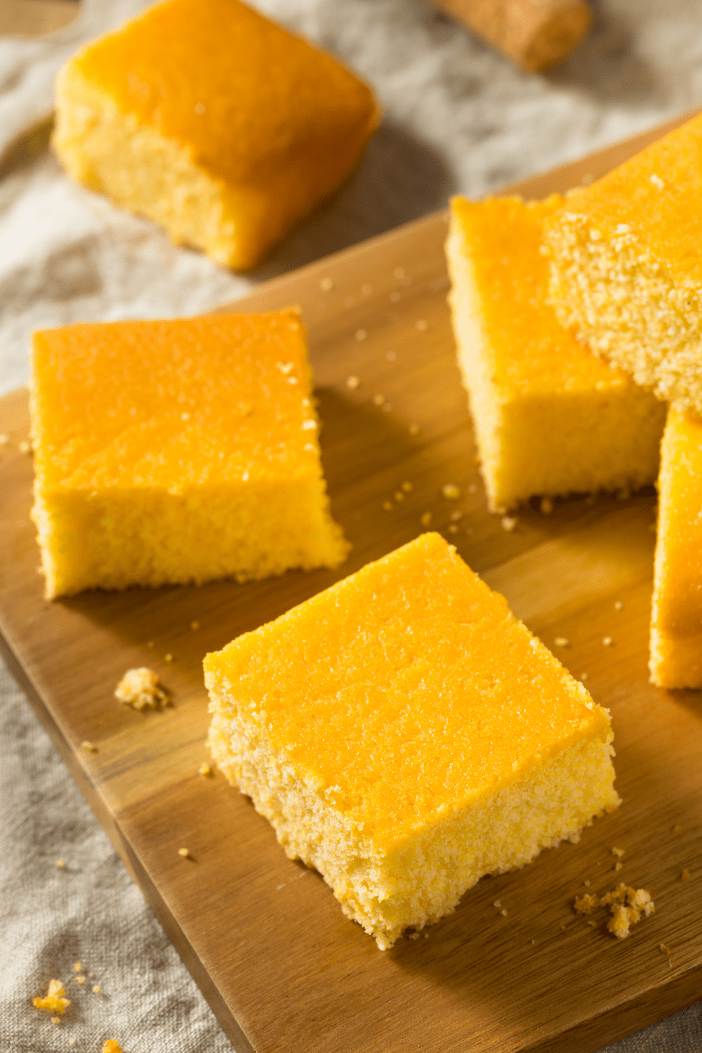 Homemade Cornbread bars in a wooden board. 