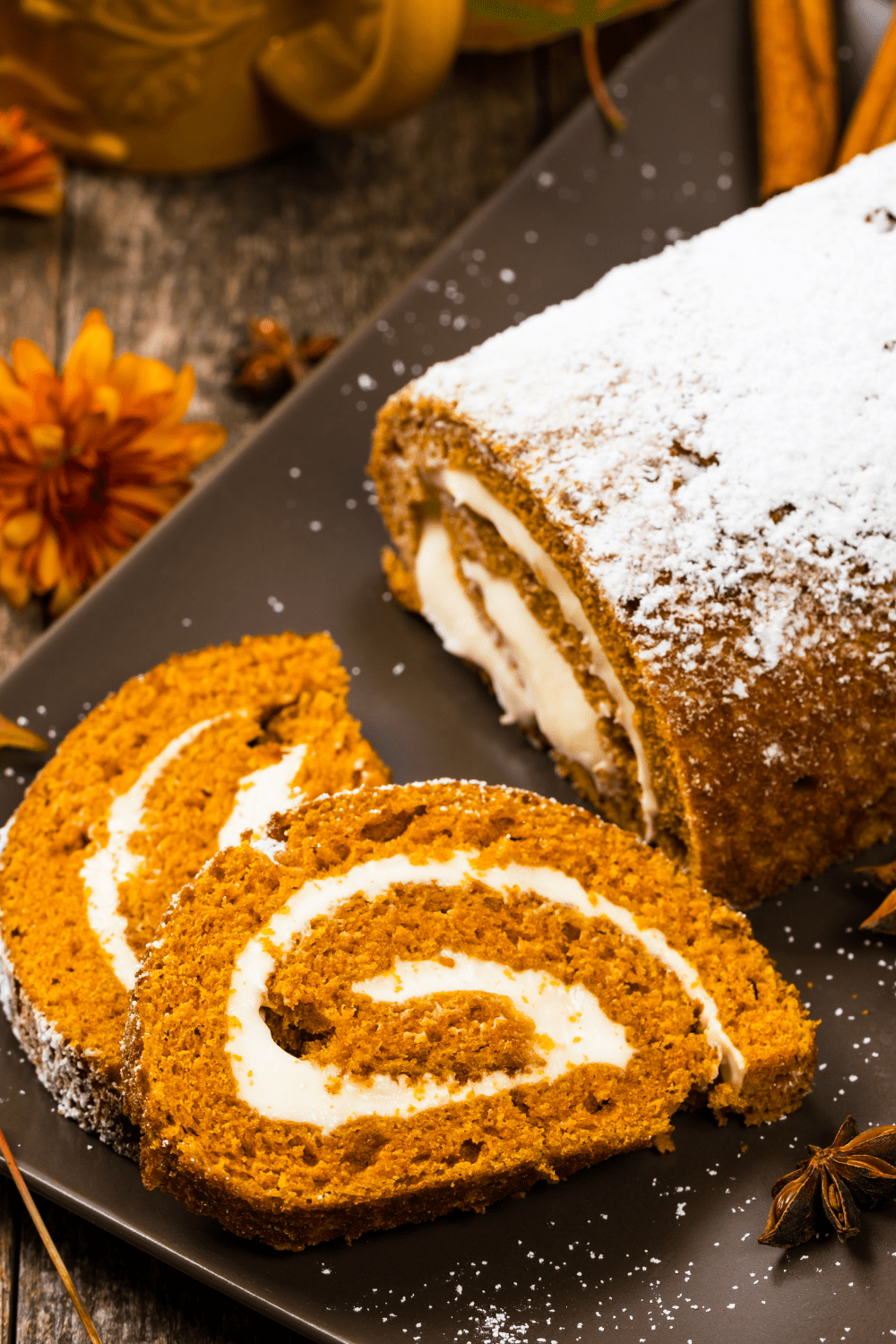 Homemade Pumpkin Roll on plastic tray with star anise on the side
