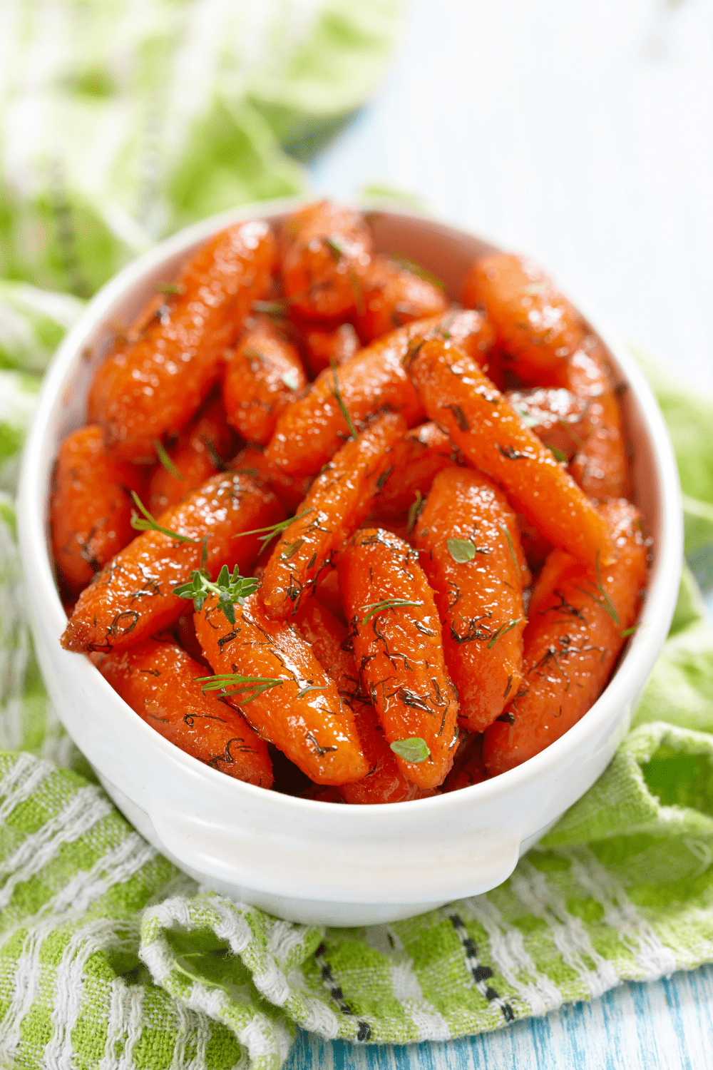 Bowl of homemade Honey Glazed Baby Carrots on close up
