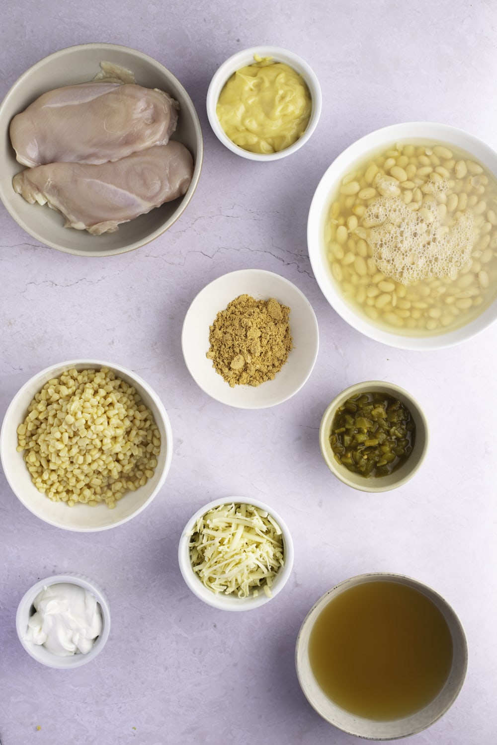 White Chicken Chili Ingredients - Boneless Chicken Breast, Beans, White Corn, Chicken Broth, Green Chiles, Taco Seasoning, Sour Cream and Cheese