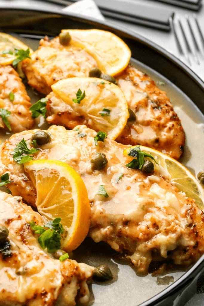Creamy chicken piccata with capers and slice of lemon. 