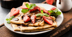 French Crepes with Strawberry and Chocolate Syrup