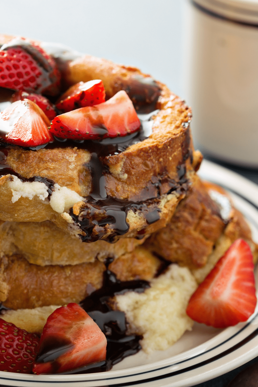 French toast with strawberries and chocolate syrup. 