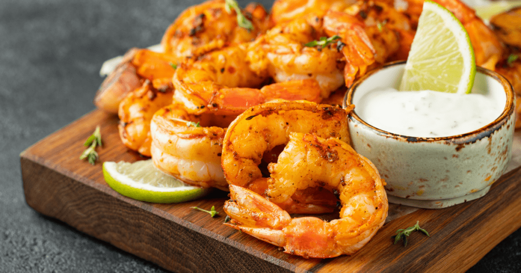 Grilled shrimp with lime wedges