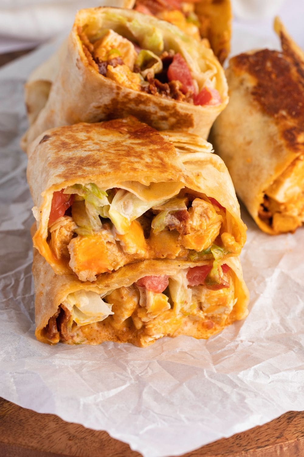 Buffalo chicken wraps with buffalo wing sauce and tomatoes. 