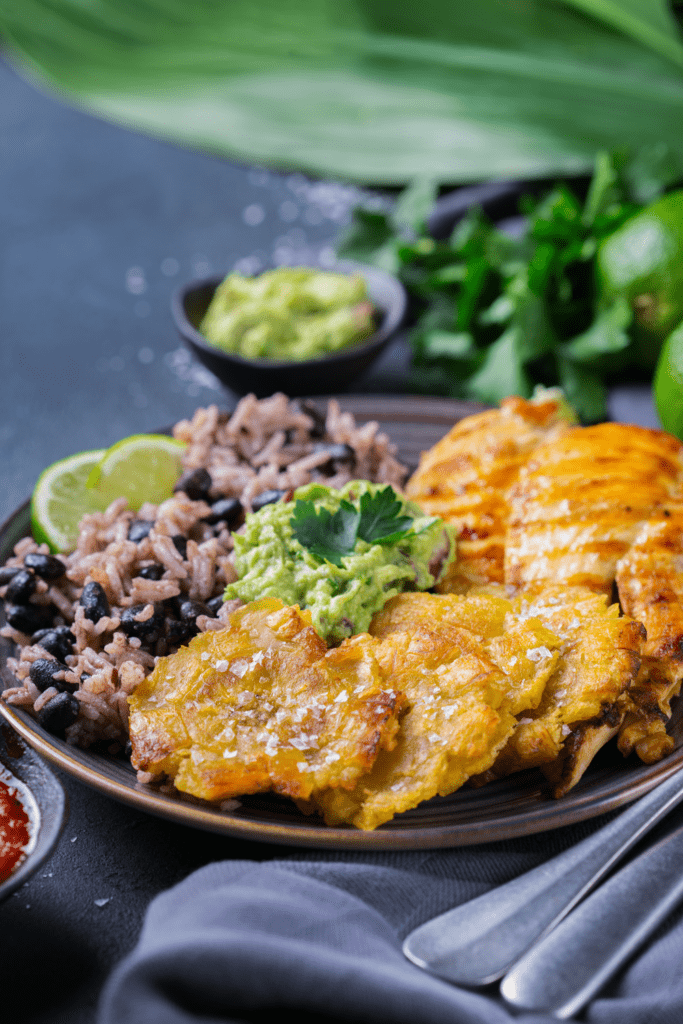 Caribbean Food: Rice with Black Beans, Fried Plantains, Chicken and Guacamole