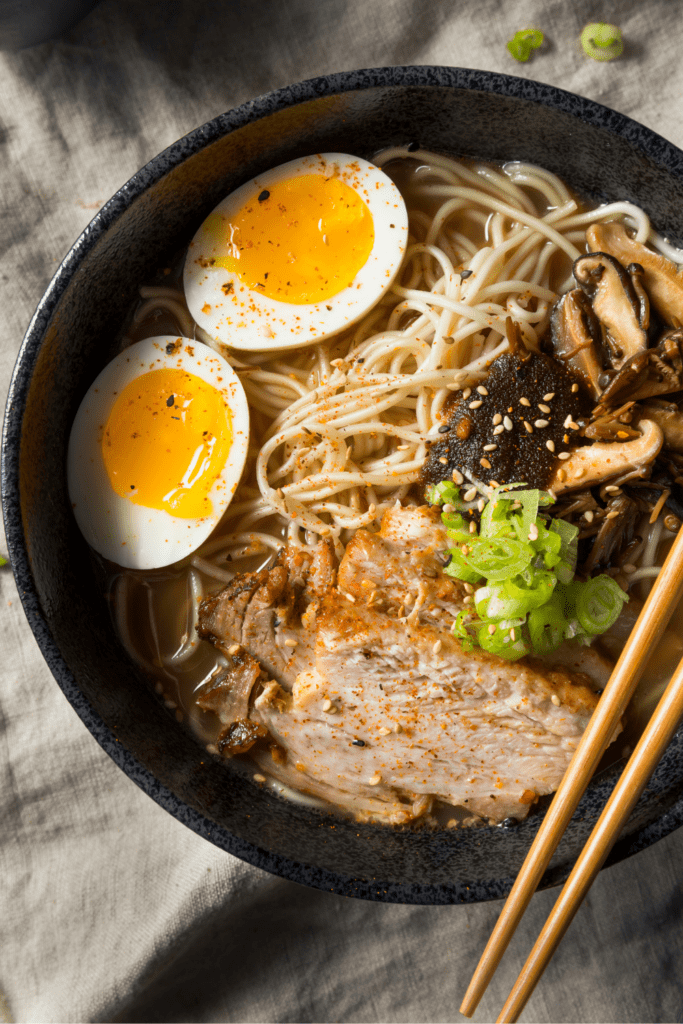 Asian Pork Ramen with Egg in a Black Bowl