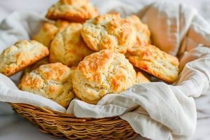Bisquick Drop Biscuits in a Basket with a Kitchen Towel