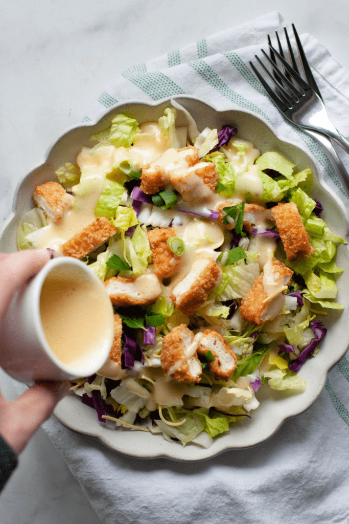 Oriental Dressing Poured Into Oriental Chicken Salad