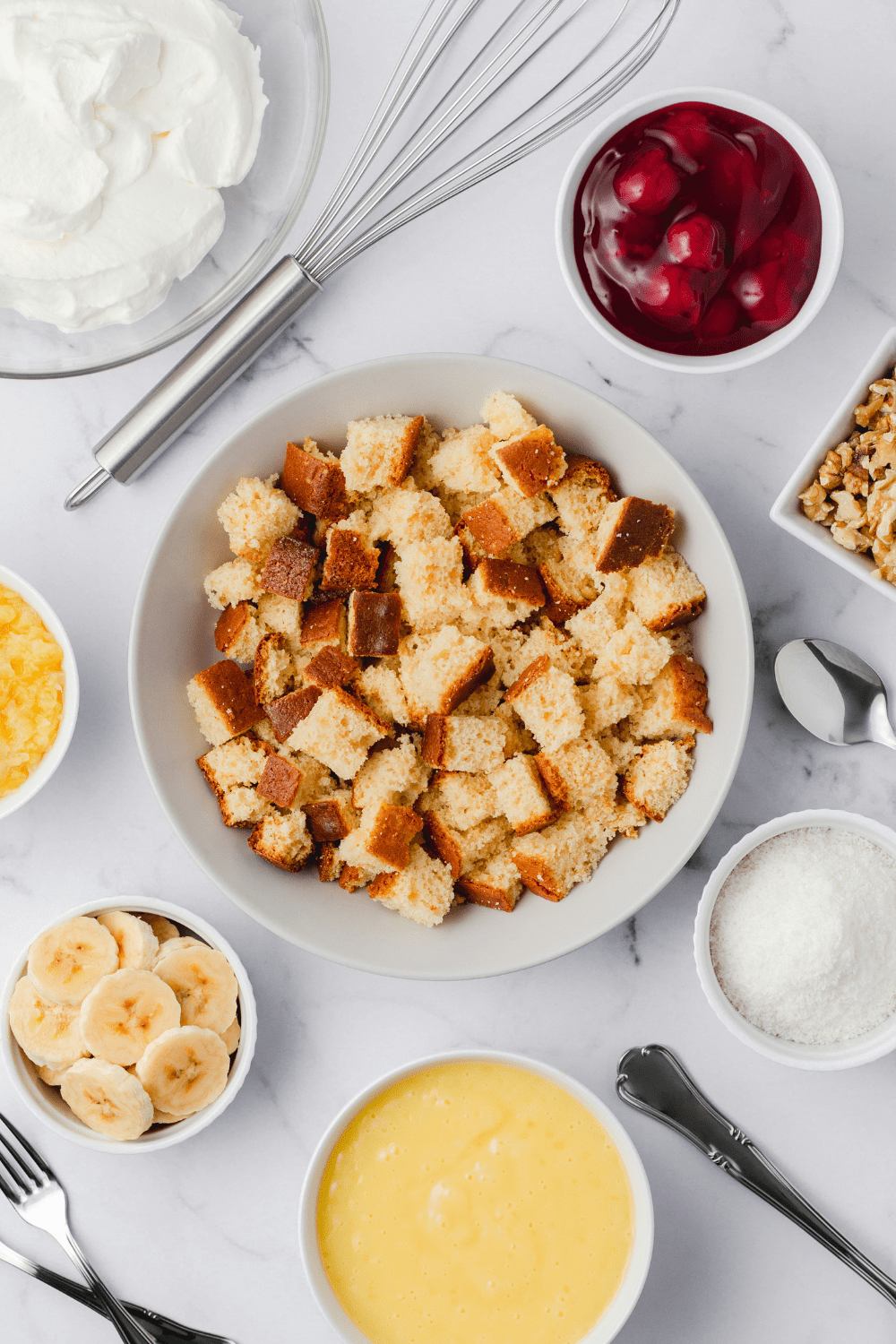 Punch Bowl Cake Ingredients: Croutons, Sliced Bananas, Coconut Flakes, Whipped Cream and Walnuts