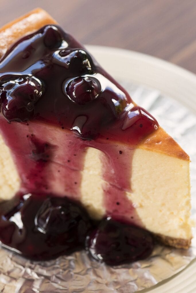 A Slice of New York Cheesecake with Blueberry Sauce