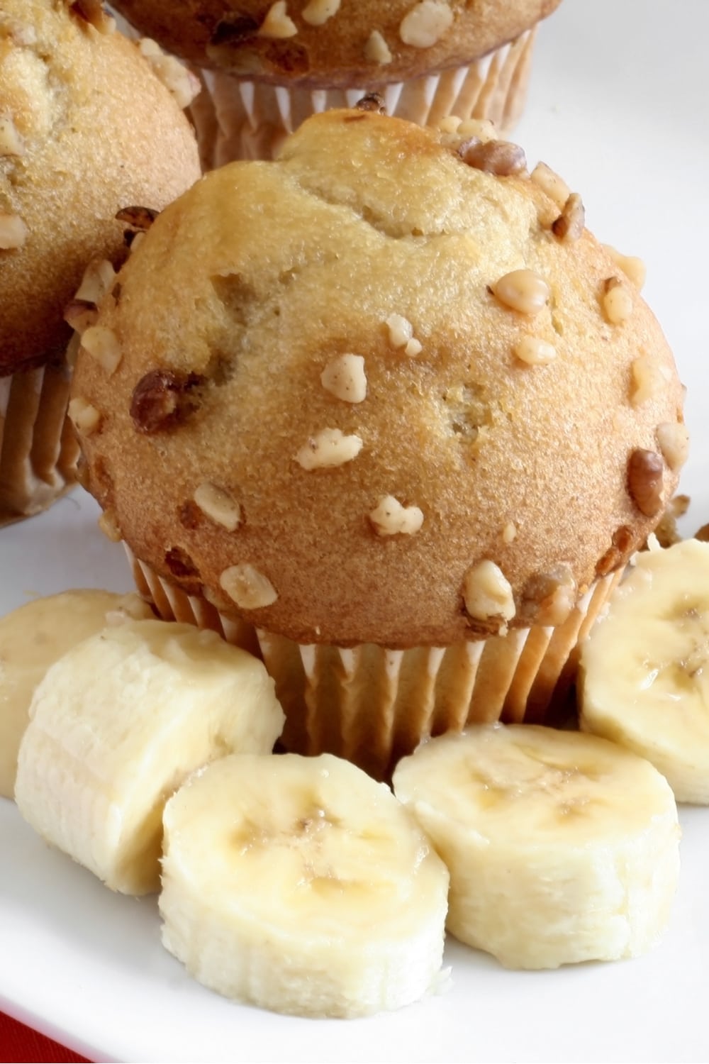 Banana muffins garnished with slices of banana.