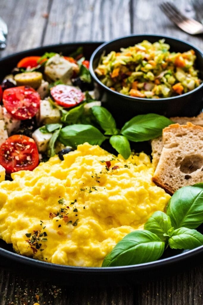 Scrambled Eggs with Greek Salad and Bread