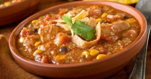 A Bowl of Chicken Tortilla Soup with Corn, Black Beans and Tomatoes