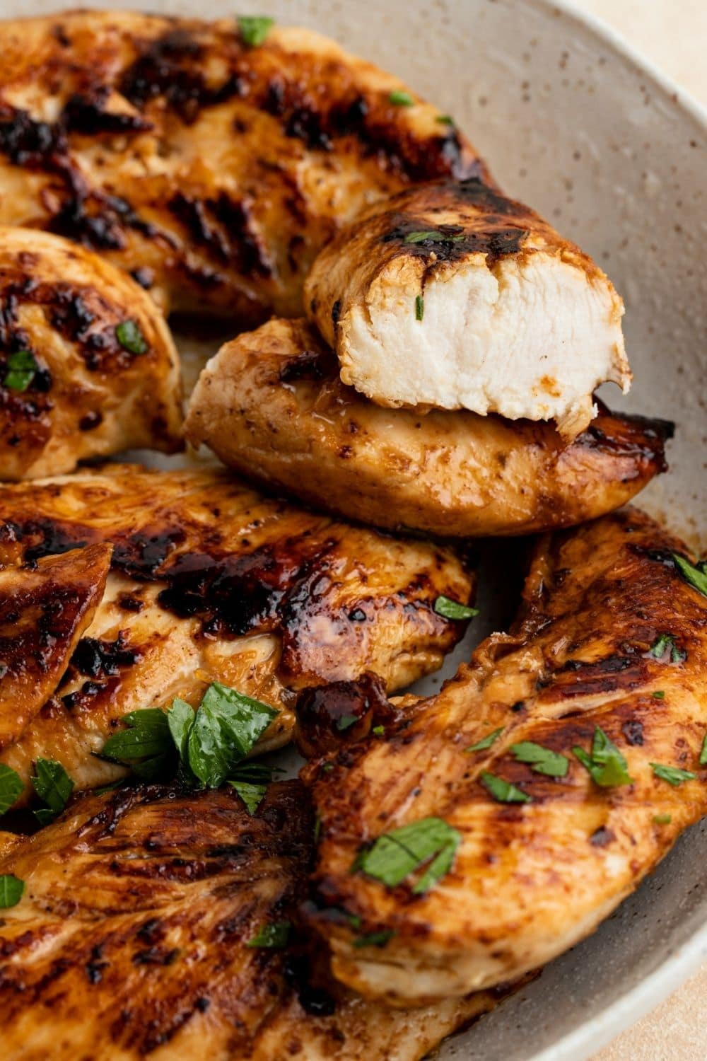 Glazed grilled chicken tenders with herbs in a plate