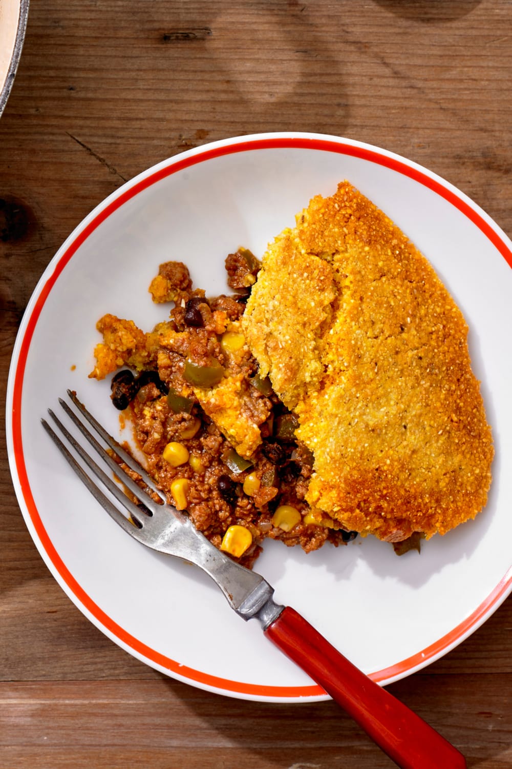Cowboy Cornbread with Ground Beef and Corn on a saucer with fork