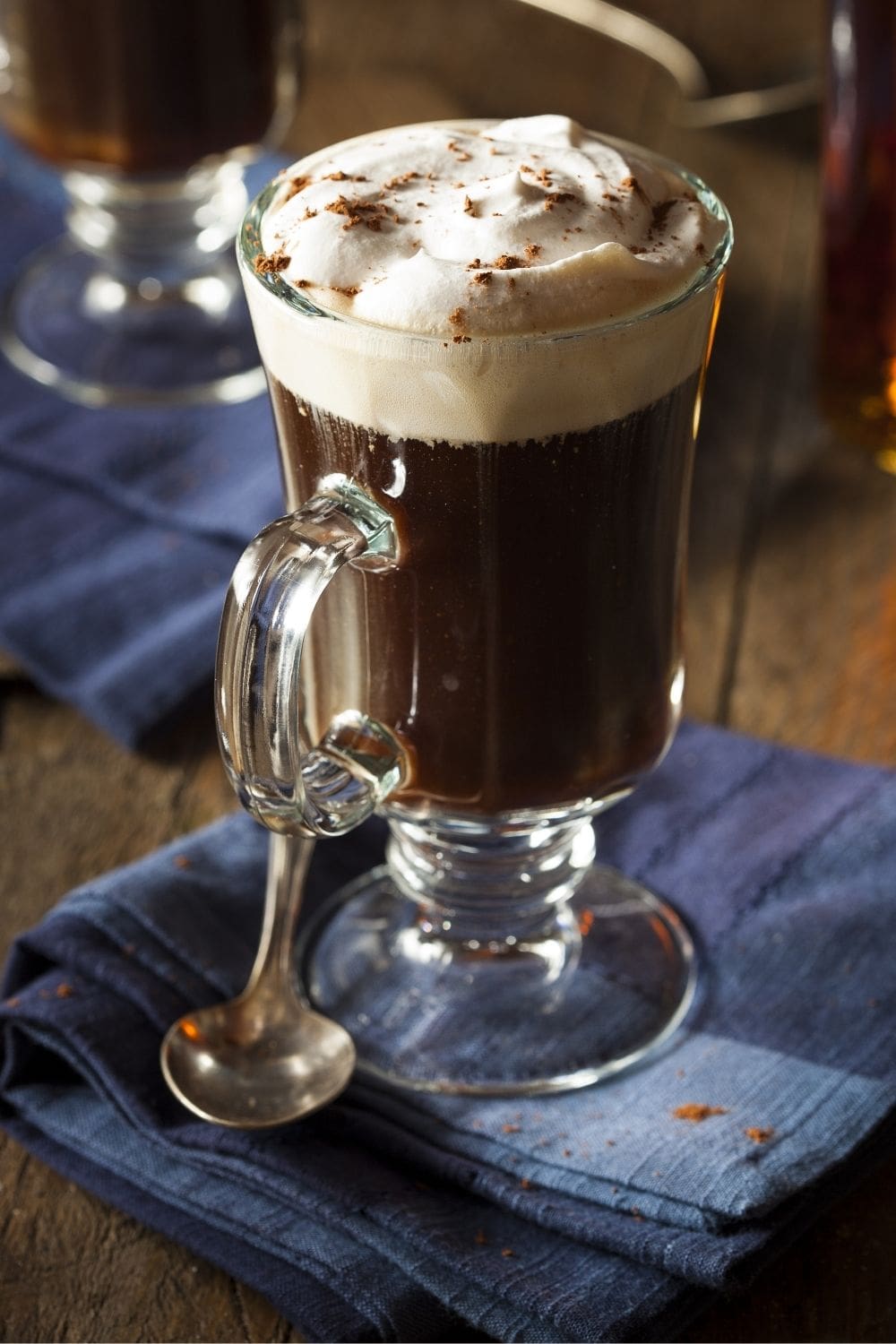 Cozy and Warming Irish Coffee with Foam and a Dusting of Cocoa Powder on Top
