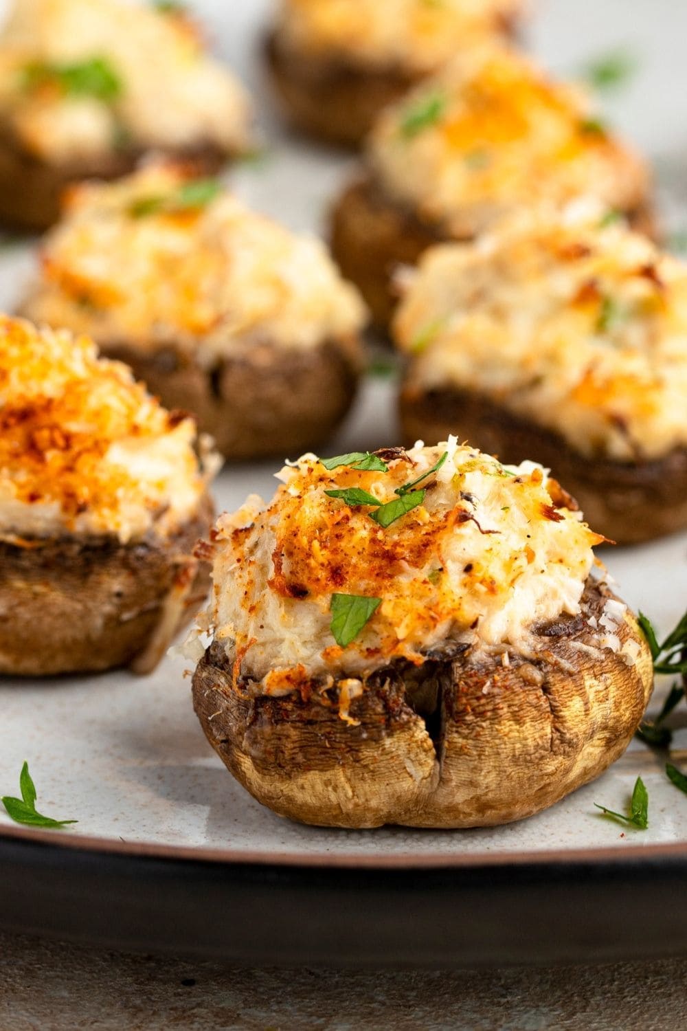 Mushroom stuffed with creamy crab meat served on a plate. 