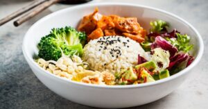 Homemade Vegan Bowl with Vegetables, Hummus and Avocados