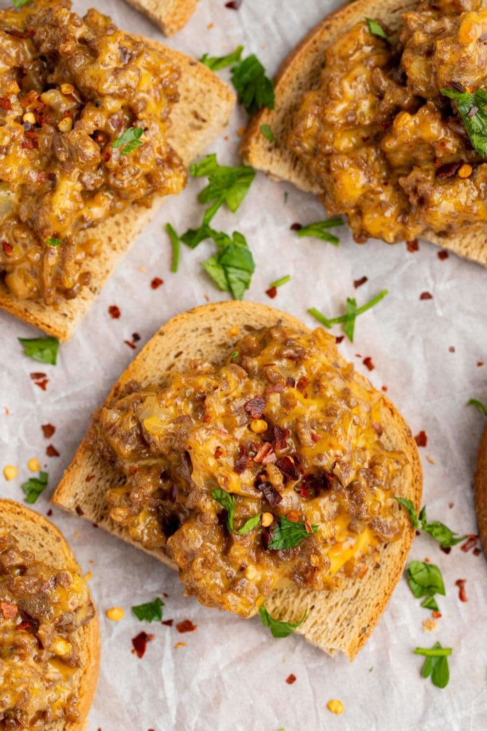 Mixture of ground beef, cheese, sausage, onions, and peppers baked on top of sliced rye bread. 