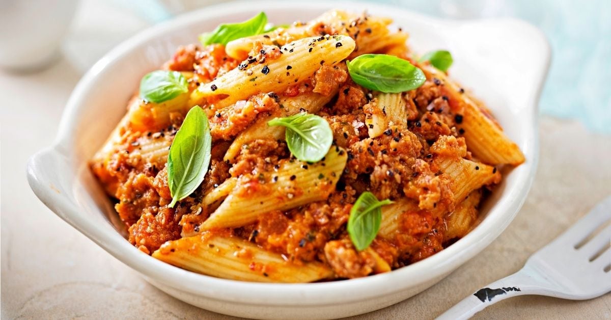 Homemade Penne Pasta with Tomato Sauce, Minced Sausage and Basil