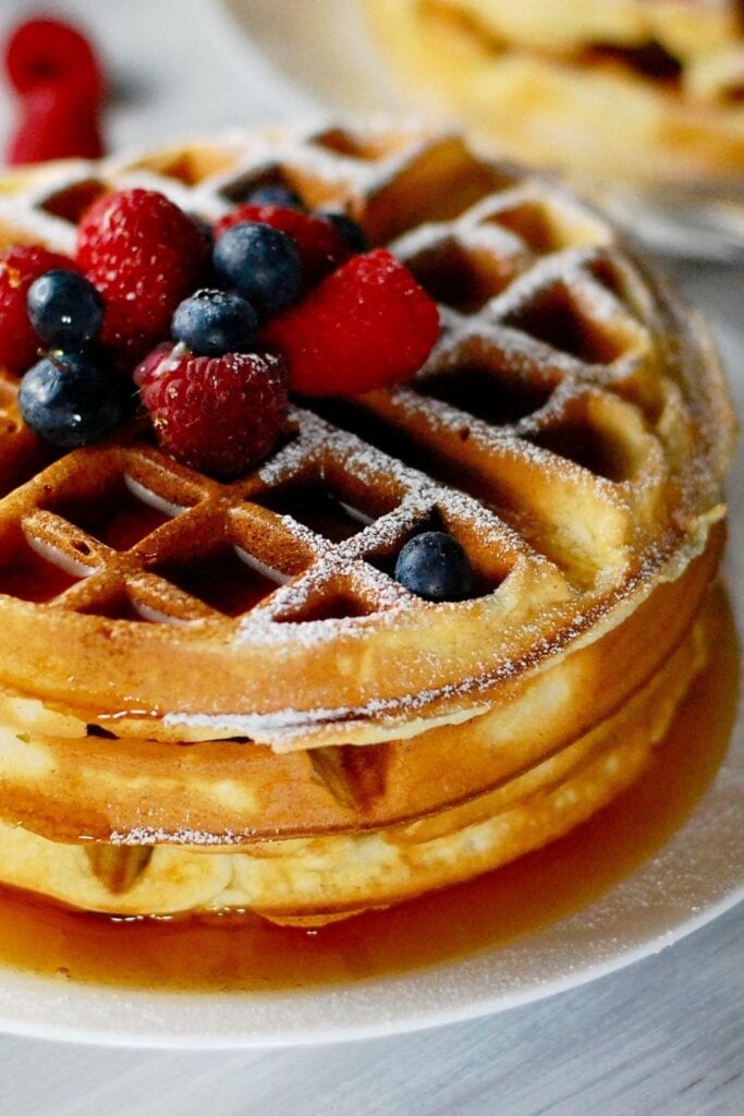 Krusteaz Waffles recipe. Photo shows Homemade Waffles with Berries and Maple Syrup on a plate
