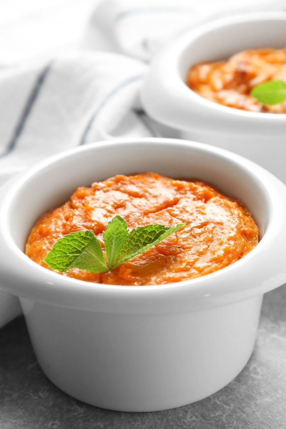 Fluffy Carrot Souffle in a White Ramekin Bowl