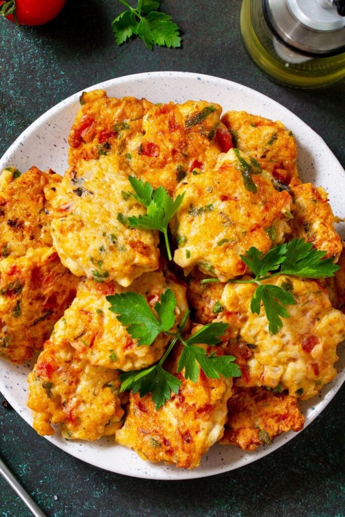 20 Best Chicken Cutlet Recipes. Photo shows Fried Chicken Cutlets Made From Minced Meat with Paprika, Onions and Greens on a plate