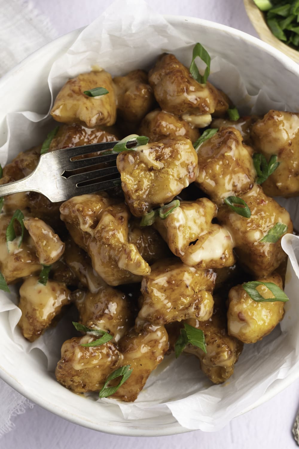 Chunks of fried chicken covered with sticky sauce.