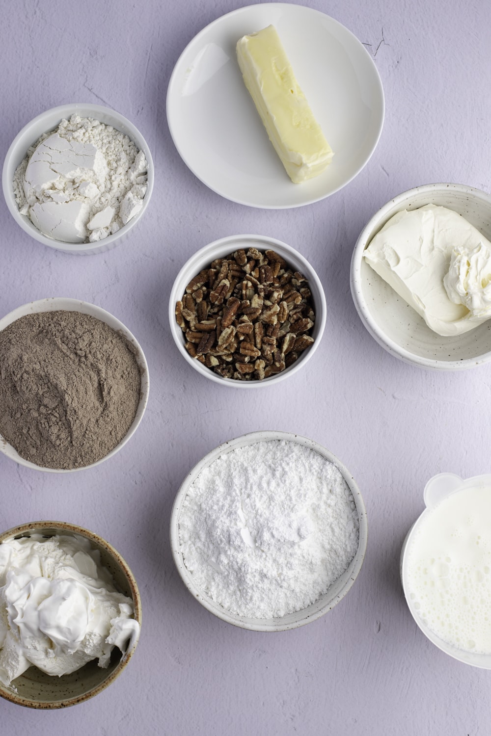 Easy Chocolate Delight Ingredients: pecans, butter, cream cheese, powdered sugar, Cool Whip, and chocolate pudding.