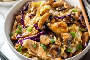 Moo Shu Chicken -Mushrooms, Cabbage, Chicken, Onions, Sesame Seeds, and Sauce- in a White Bowl with Chopsticks