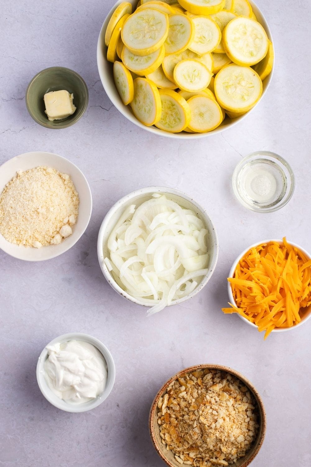 Paula Deen Squash Casserole Ingredients: Summer Squash, Vidalia Onion, Butter, Parmesan Cheese, Sour Cream and Crushed Butter Crackers
