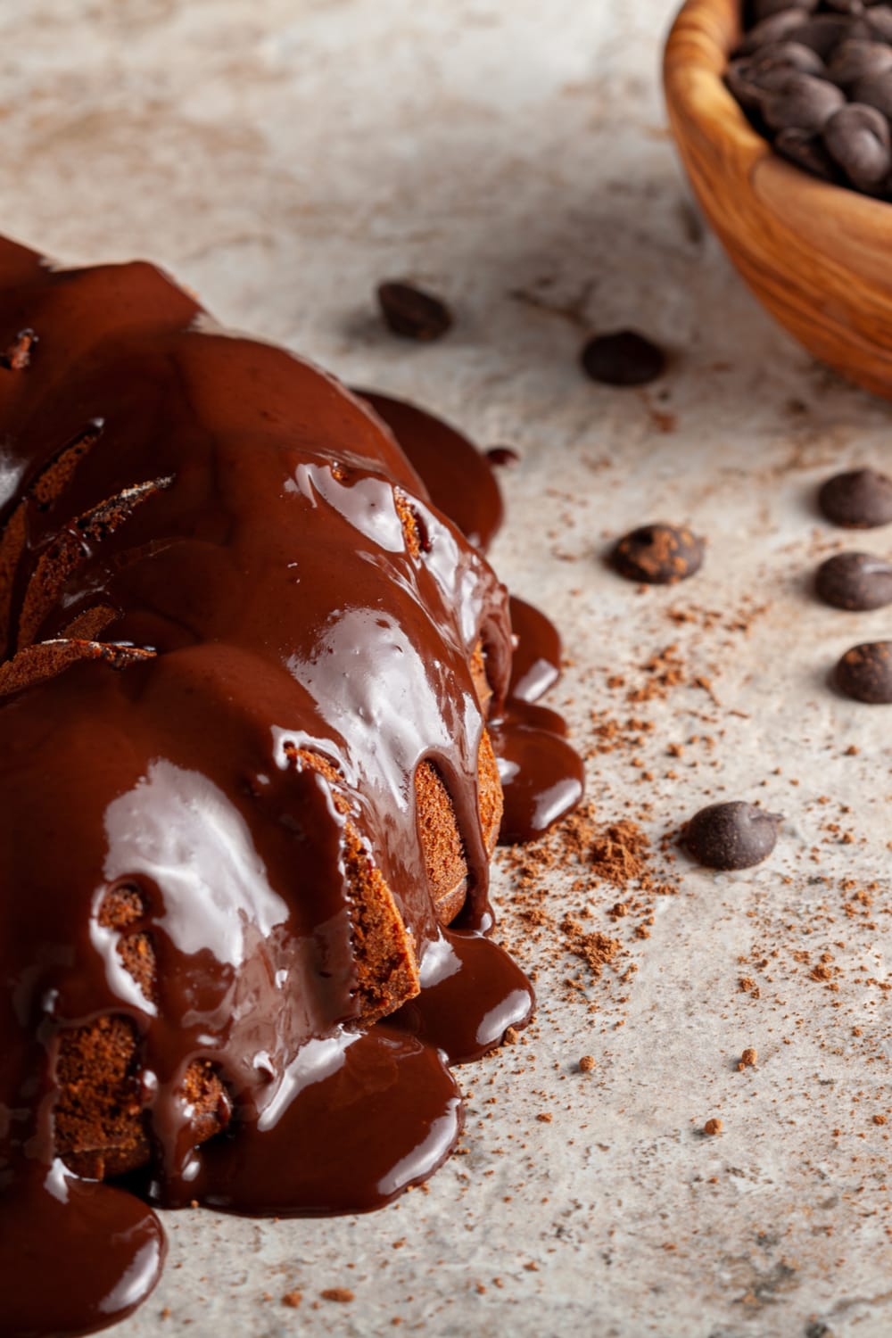 Chocolate cake with chocolate chips topped with dripping sugar glaze. 