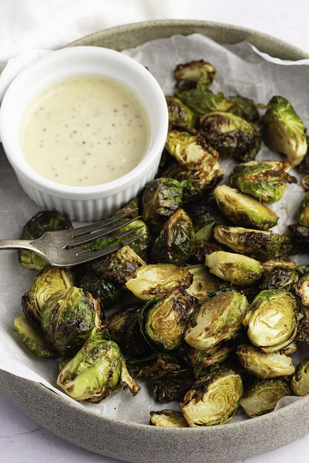 Air Fryer Brussels Sprouts on a plate with dipping sauce