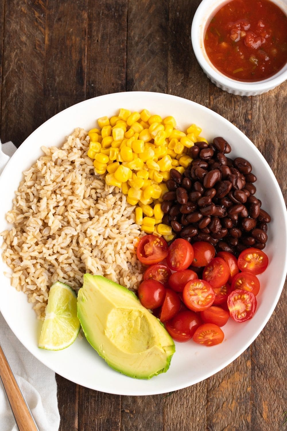 Homemade Mexican Buddha Bowl with Salsa in a Wooden Table