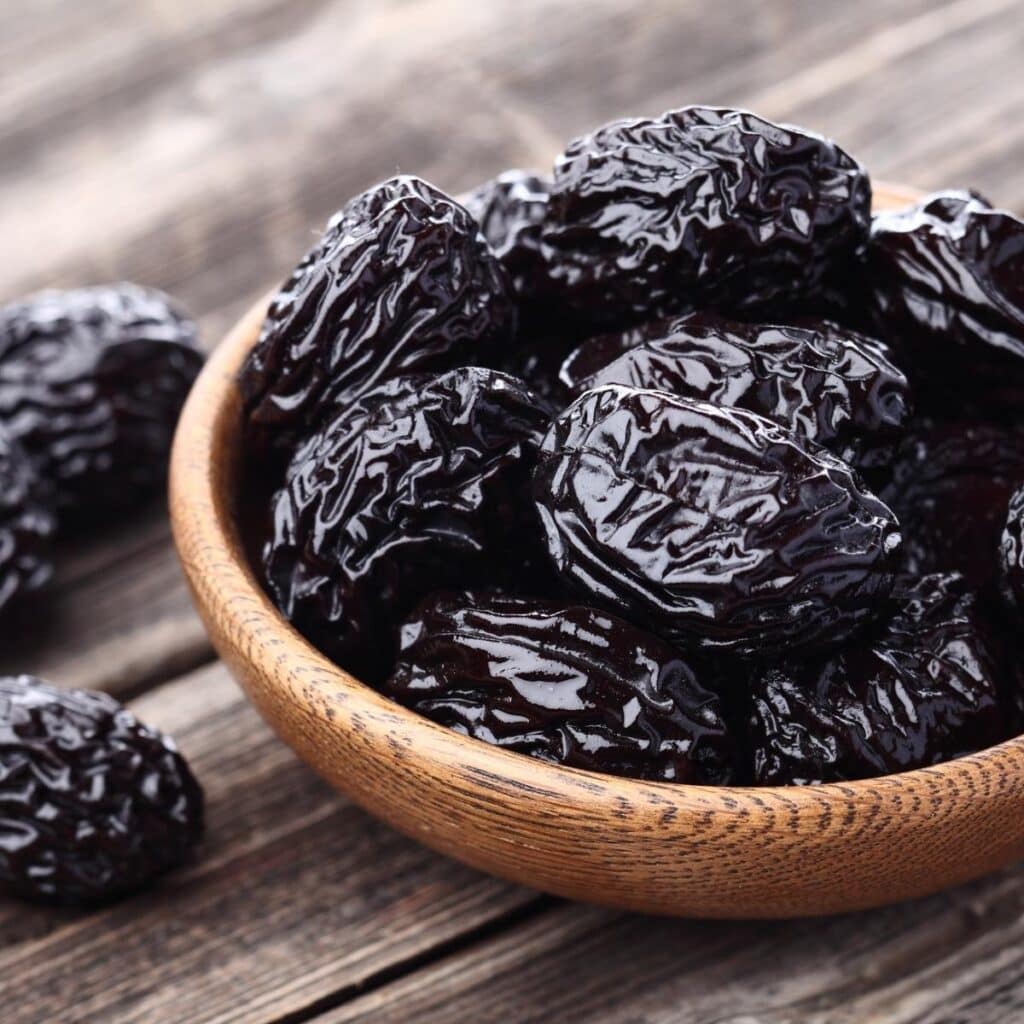 Prunes in a Round Wooden Dish