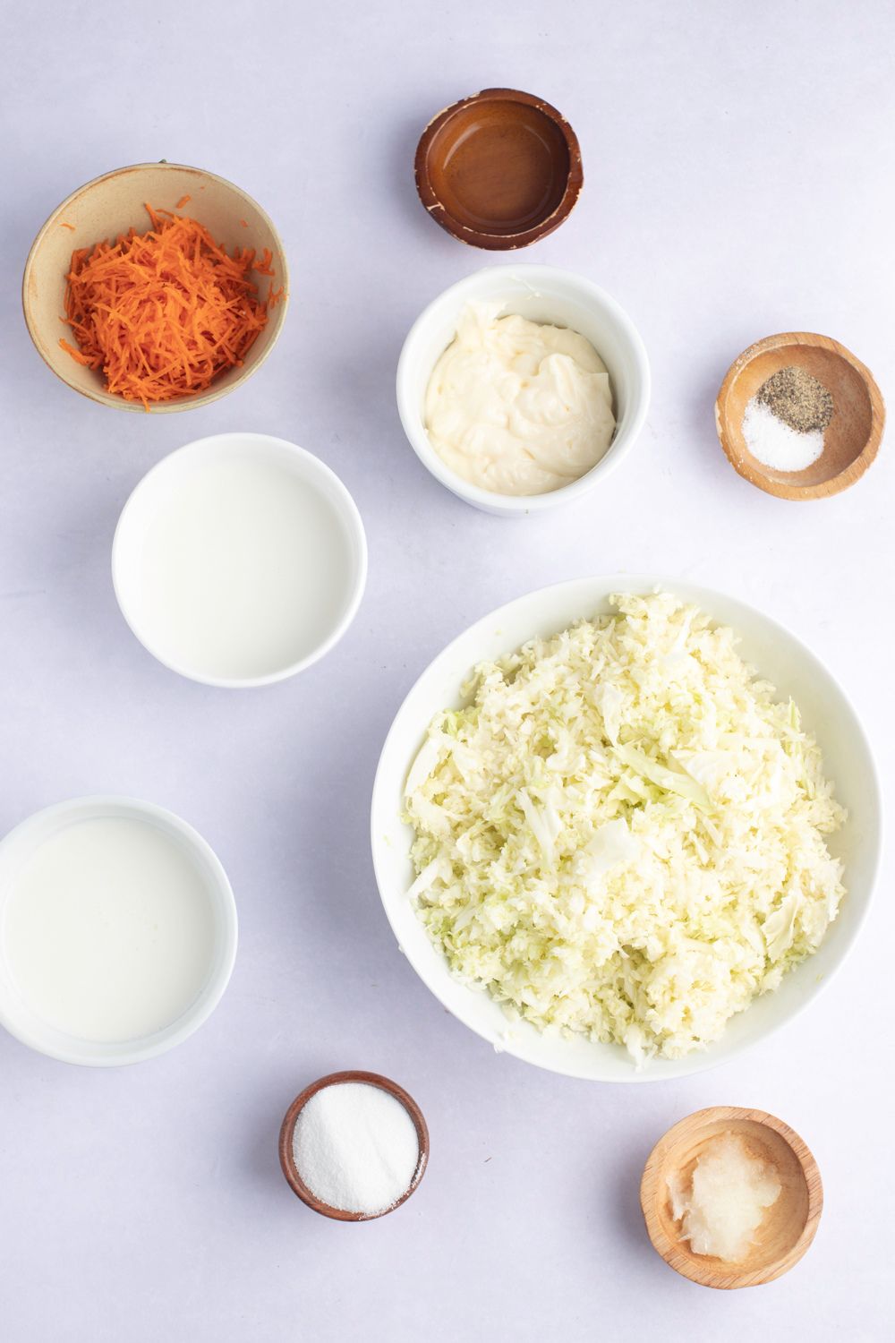 KFC Coleslaw Ingredients - Chopped Cabbage, Carrots, Mayonnaise, Milk, Buttermilk, Sugar, Lemon, Juice, Salt, Pepper and Chopped Onions