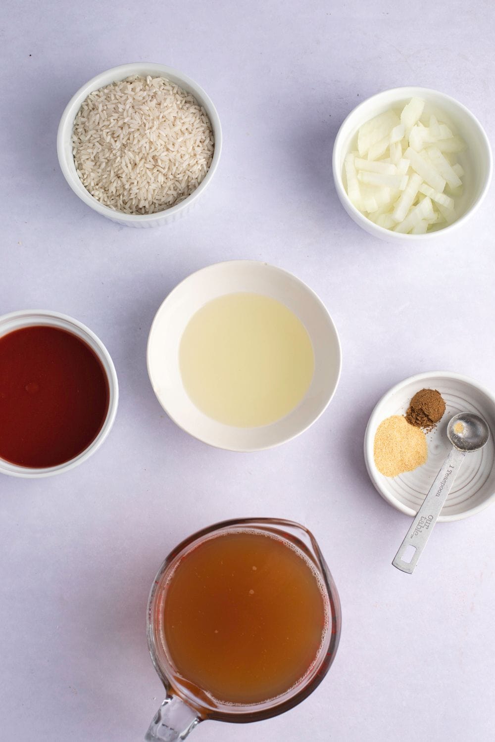 Mexican Rice Ingredients - Long Grain Rice, Garlic Salt, Ground Cumin, Chopped Onions, Tomato Sauce and Chicken Broth