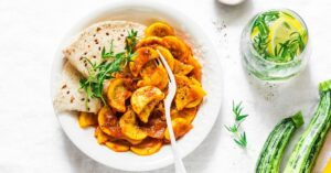 Zucchini Curry with Naan Bread and a Glass of Lemonade