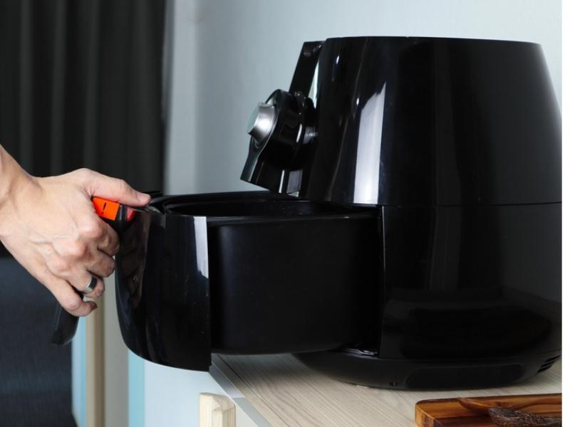 Person removing Air Fryer basket