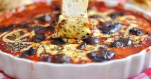 Bowl of Homemade Pizza Dip with Garlic Bread