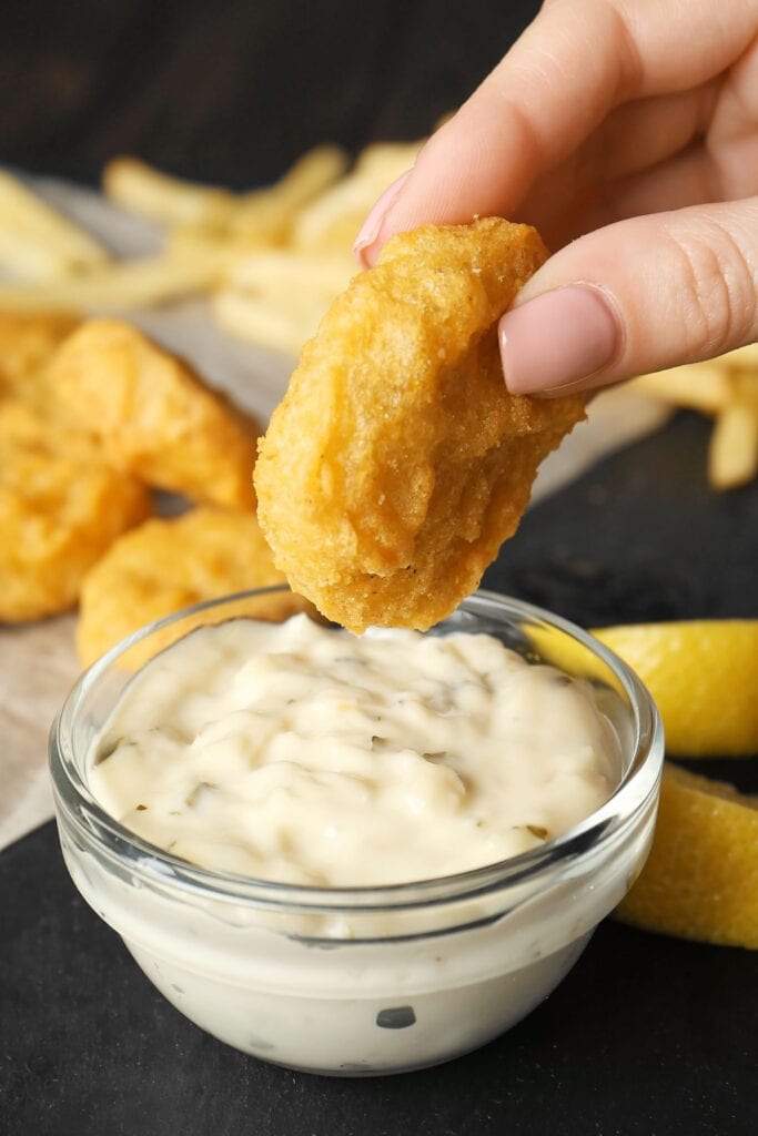 Chicken nugget dipped in McDonald's Tartar Sauce