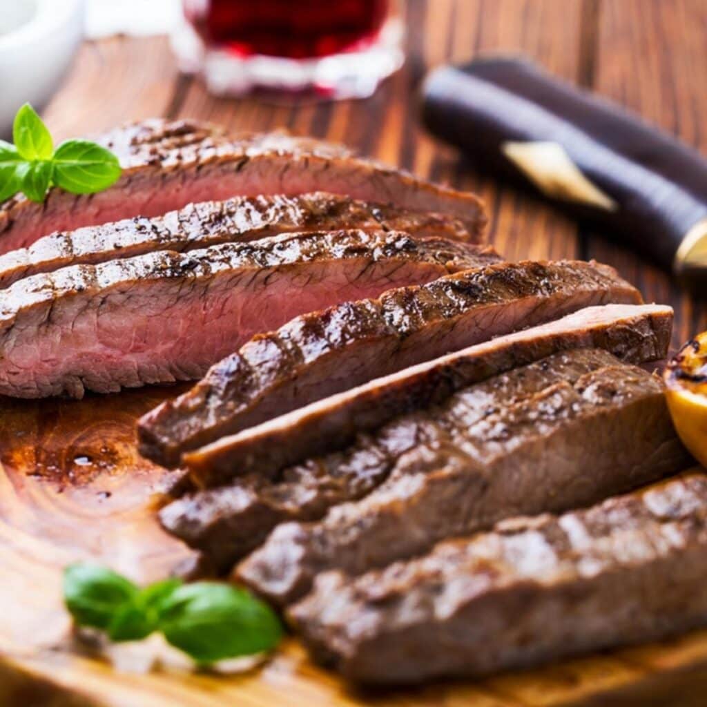 Cooked Steak Slices on a Wooden Chopping Board
