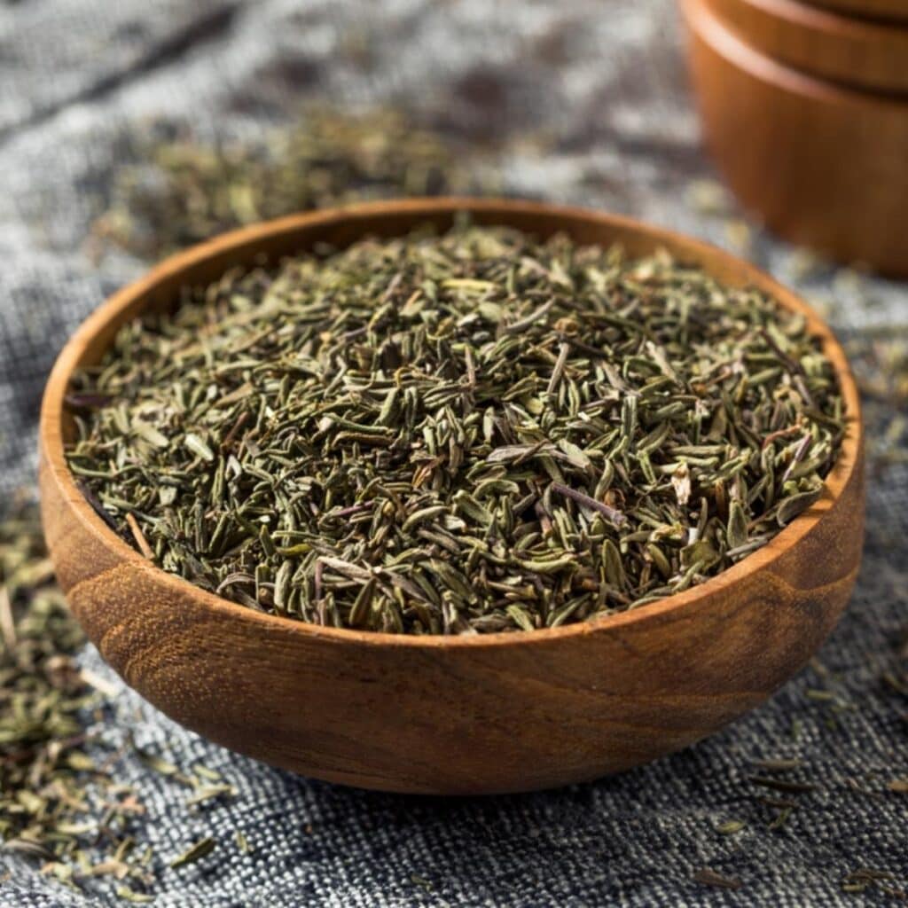 Dried Thyme Leaves in a Wooden Bowl